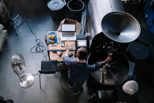 A coffee roaster fine tuning his equipment